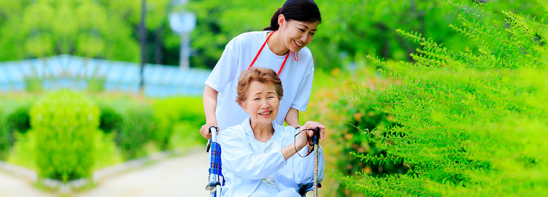 elderly woman on wheelchair with the staff